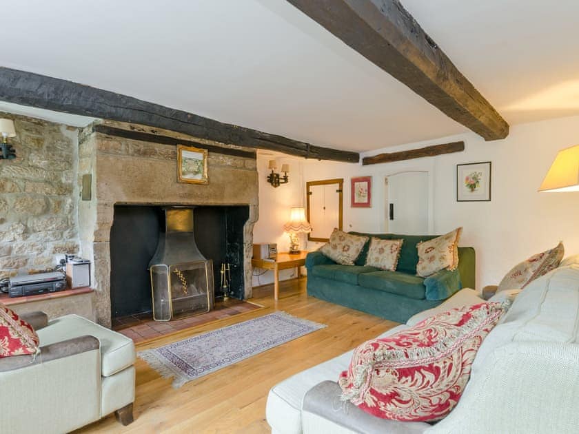Living room with inglenook fireplace and open fire | Brookside Cottage, Beeley, near Chatsworth