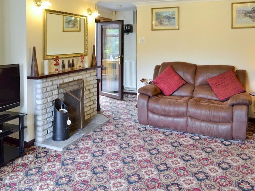 Spacious living room with open fire | Coombe End Cottage, Carn Brea, Redruth