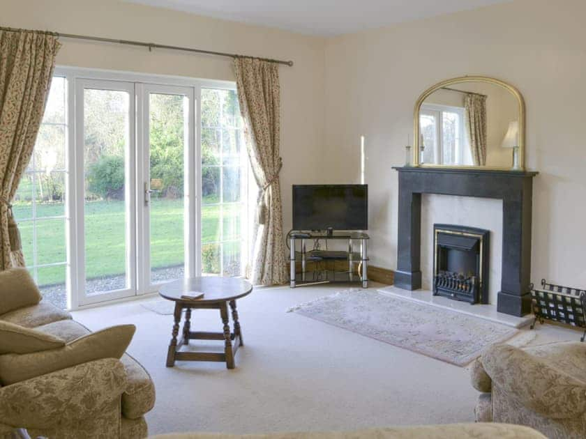 Spacious living area with French doors to garden | Alby Bungalow, Cumwhinton, Carlisle