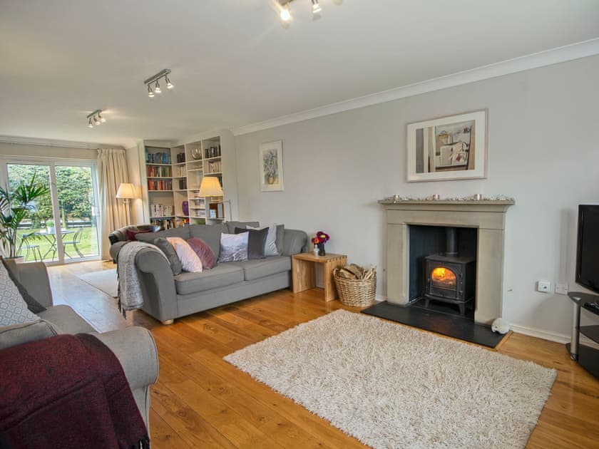 Beautifully presented living room with woodburner | Sunshine House, Seahouses