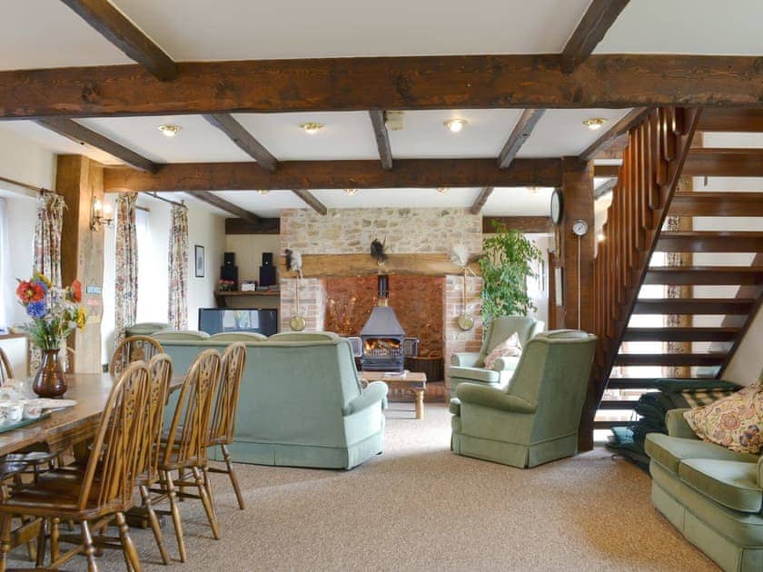 Spacious living/ dining room with beamed ceiling and wood burner | The Granary, Colyford, near Seaton
