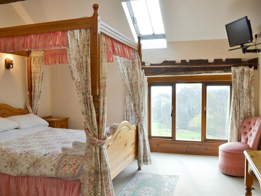 Large, spacious bedroom with a four poster bed | The Granary, Colyford, near Seaton