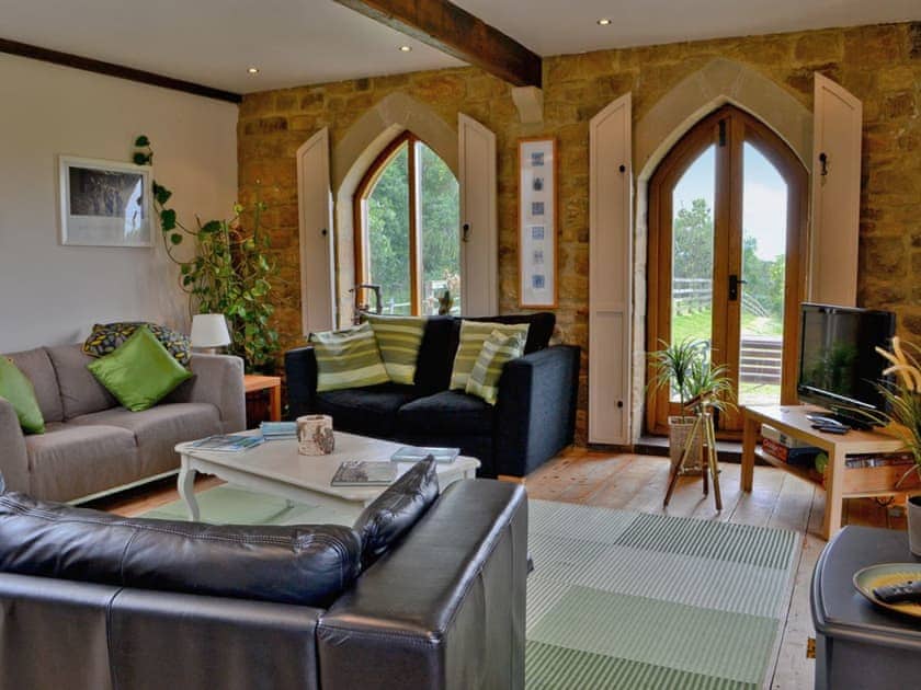 Comfortable living area with wooden floor and electric wood-burner | The Water Castle, Newton, near Corbridge
