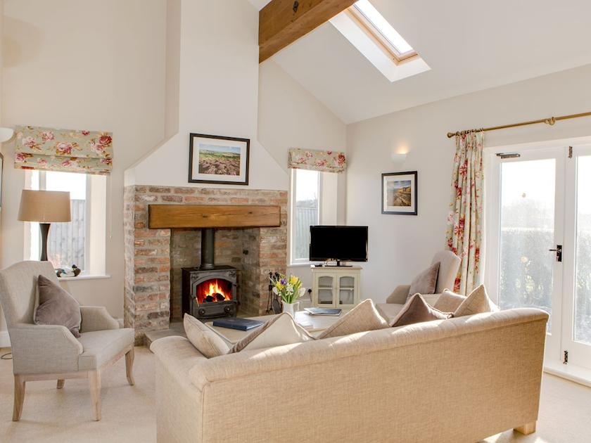 Spacious beamed living/dining room with wood-burning stove | Lodge Cottage - Scalby Lodge, Scalby, Scarborough