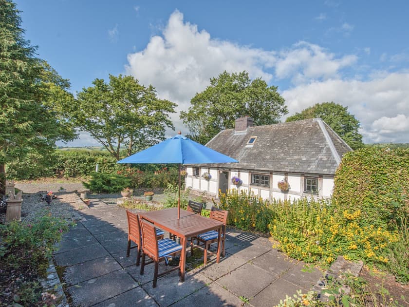 Exterior of the A Grade II listed 17th century timber and stone holiday cottage | Pen Copi, Trefeglwys, near Caersws