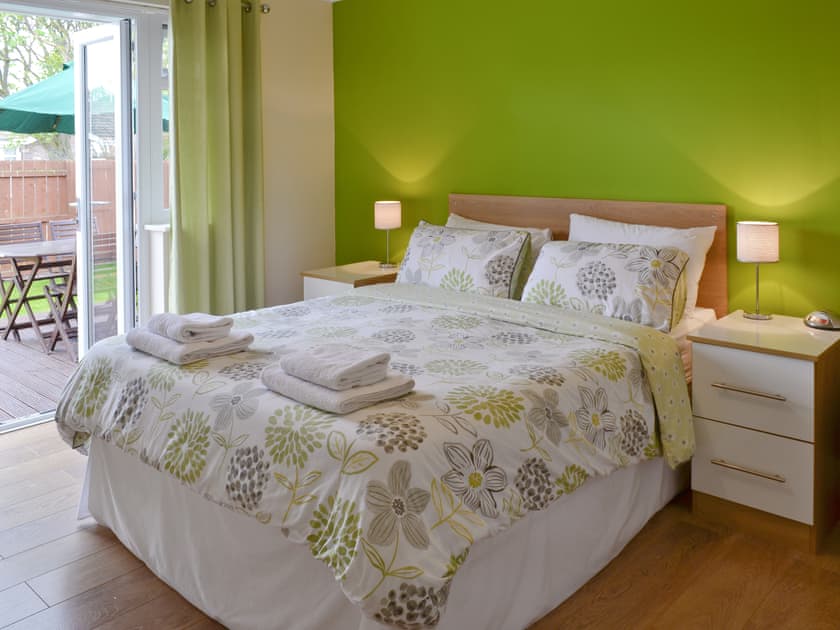 Comfortable double bedroom with French doors to garden | Coastal Retreat, Beadnell