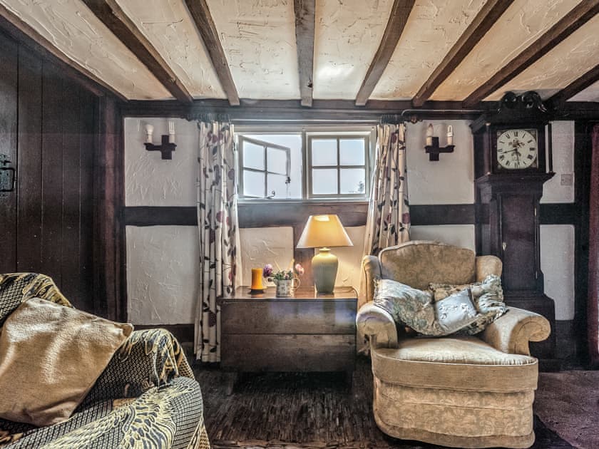 Living room with cobbled floor, open fire and many original features | Pen Copi, Trefeglwys, near Caersws