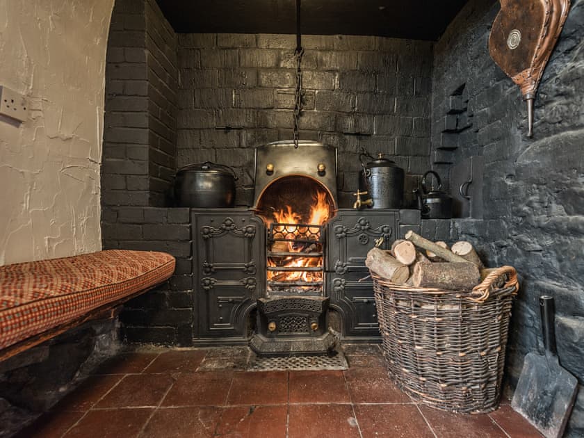 Living room with cobbled floor, open fire and many original features | Pen Copi, Trefeglwys, near Caersws