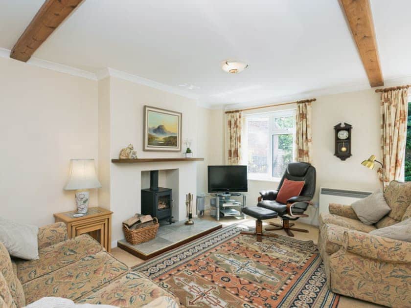 Spacious living/dining room with wood-burning stove and French doors | Camelot, Weybourne, near Holt