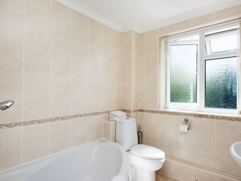 Bathroom with corner bath | Camelot, Weybourne, near Holt