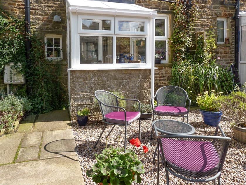 Outdoor furniture on stone patio | Curlew Cottage, Gargrave near Skipton