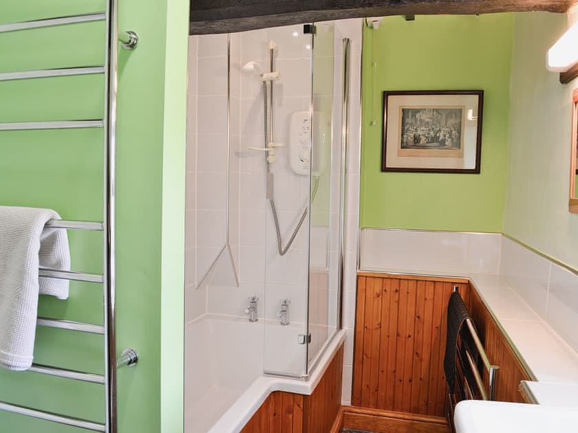 Well-presented bathroom with shower over the bath and heated towel rail | Little Knott, Blawith, near Coniston