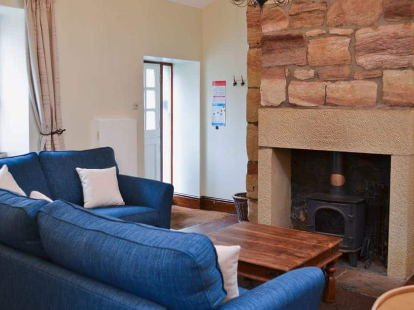 Living room area with a cosy woodburner  | The Coracle, Seahouses