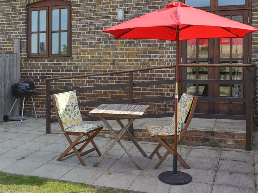 Patio with outdoor furniture and BBQ | The Stable - Decoy Farm Holiday Cottages, High Halstow, near Rochester