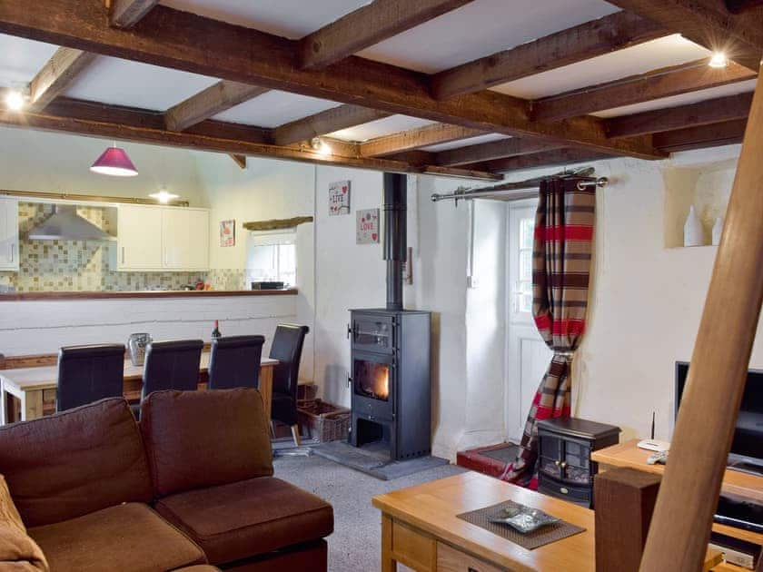 Open aspect lounge / diner / kitchen with traditional wooden beamed ceiling | Granary Cottage - Ivy Court Cottages, Llys-y-Fran