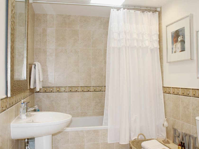 The sumptuous bathroom has a shower over the bath | West Crook, Tughall Steads, near Beadnell