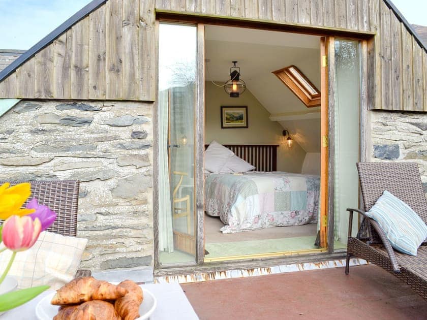 Double bedroom leading out to the large balcony for relaxing with a lazy breakfast or enjoying a meal surrounded by glorious views of the Ystwyth valley | Penroc - Ty Mari-Penroc, Cwmystwyth, Aberystwyth