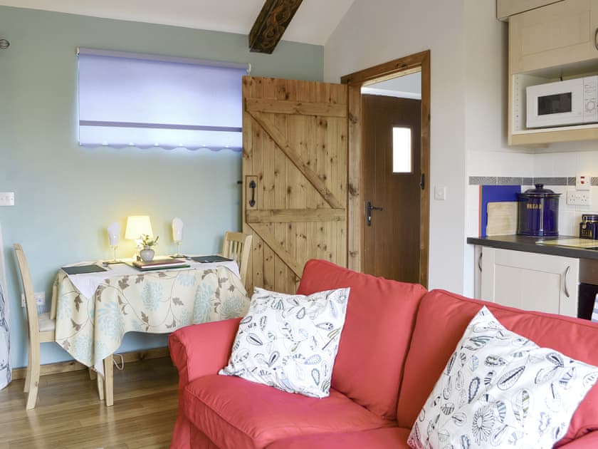 Convenient dining area and exposed carved wooden beams | Shepherdskirk - Wide Sky Cottages, Lowick, near Berwick-on-Tweed