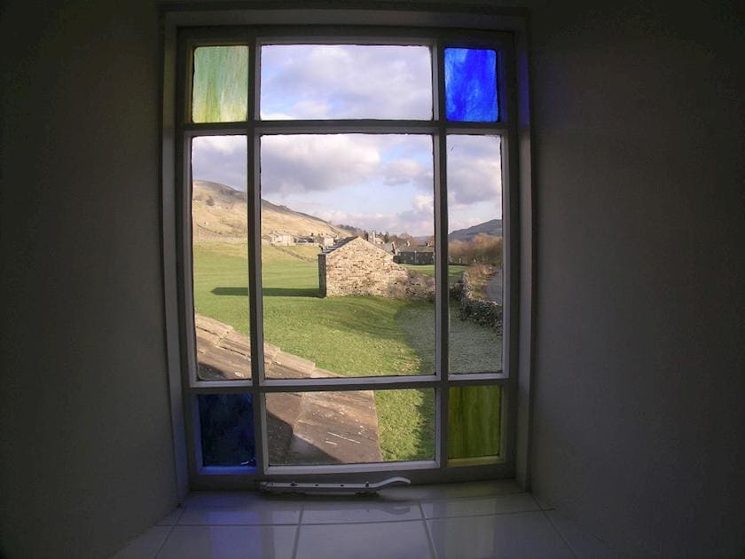 Traditional stained glass window with stunning country view | Arngill, Muker