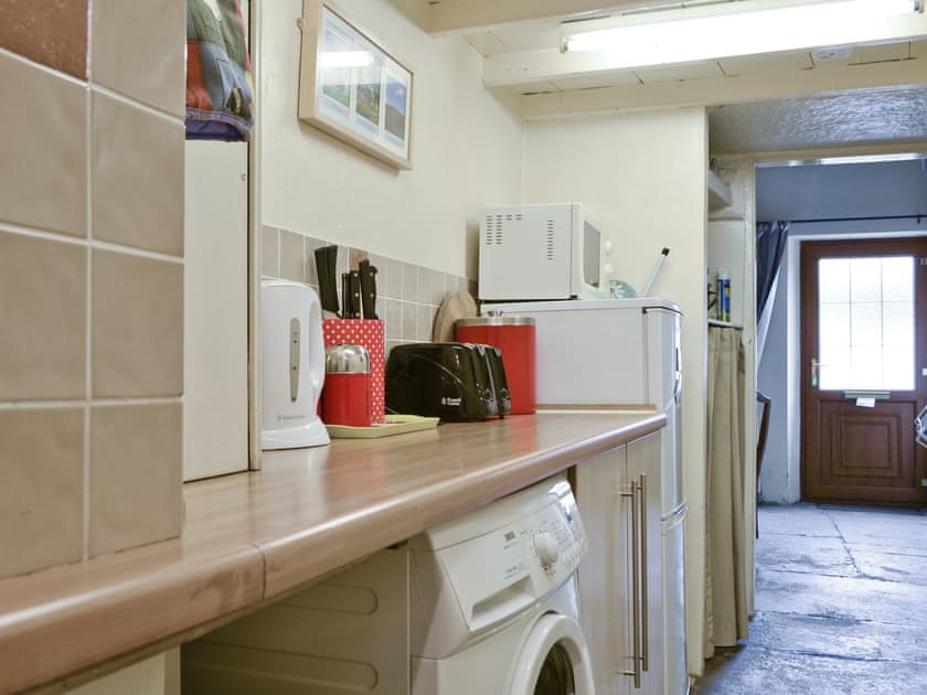 Convenient utility and work area of galley style kitchen | Cattlemarket Cottage, Hawes