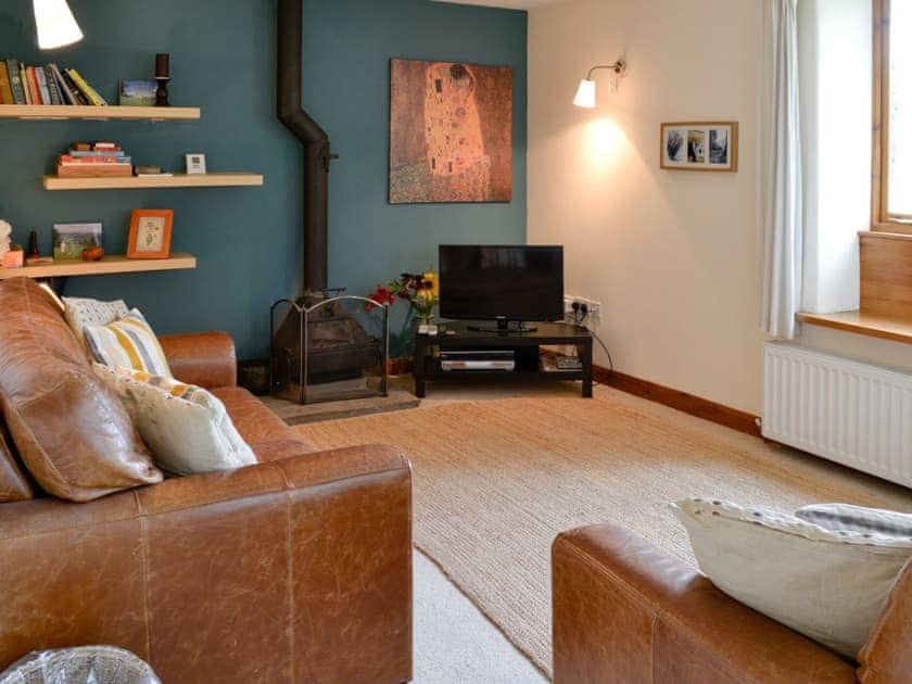 Living room with wood burner | Hollyhock Cottage, Thorns near Hawes