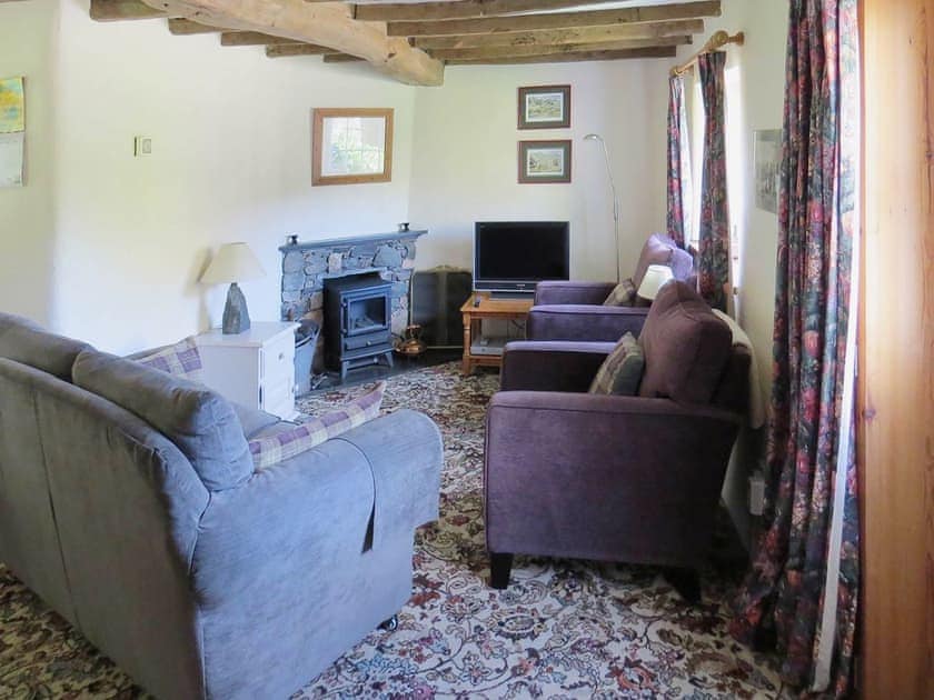 Beamed living room with feature fireplace | Garries Cottage, near Bassenthwaite