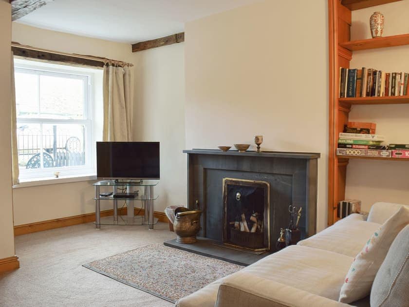 Living/ dining room with cosy open fire | Bridge House, Threlkeld