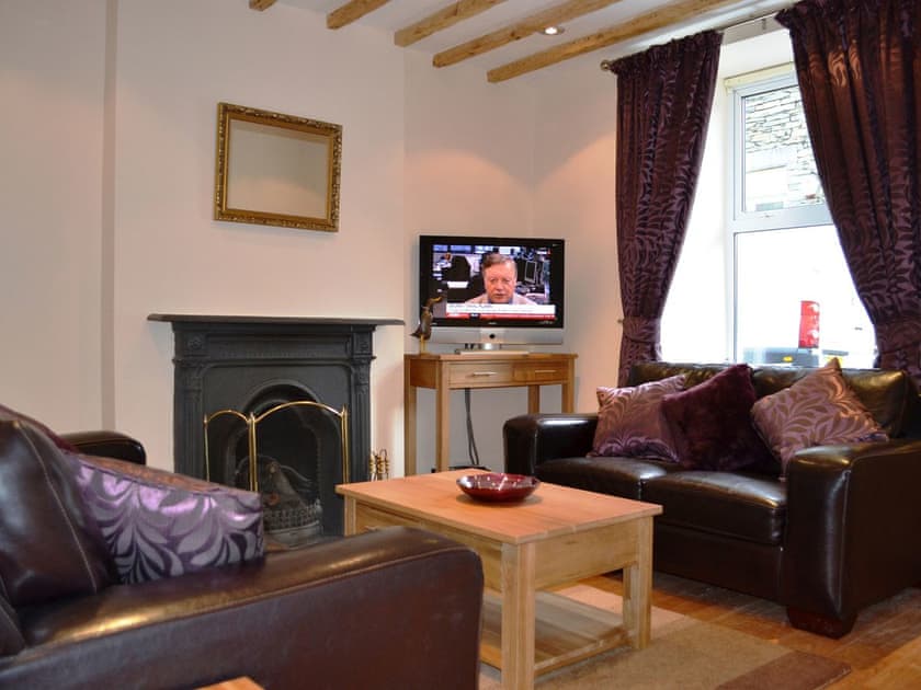 Living room with wooden floor and exposed beams | Duckling Cottage, Bowness on Windermere