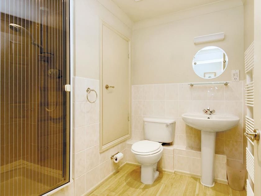 Bathroom with shower cubicle, basin and WC | St Elmo Court 7, Salcombe