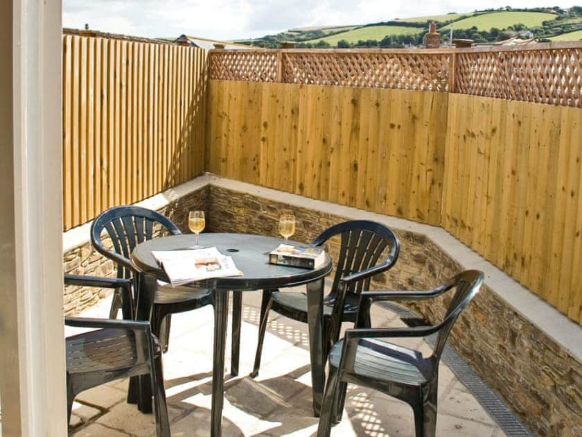 Rear patio with outdoor furniture and drying area | Retreat Cottage, Salcombe
