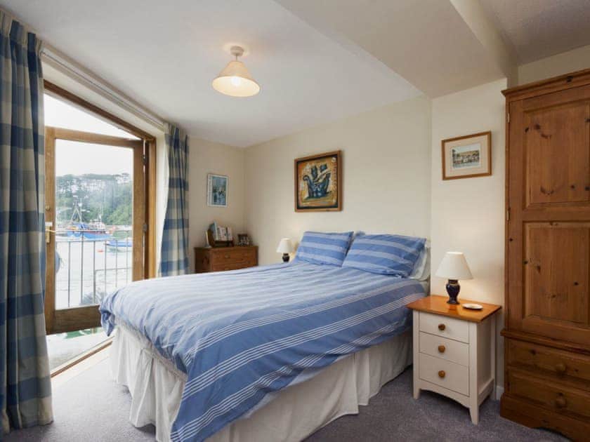 Double bedroom with patio doors to balcony overlooking the water | Tappers Quay 4, Salcombe