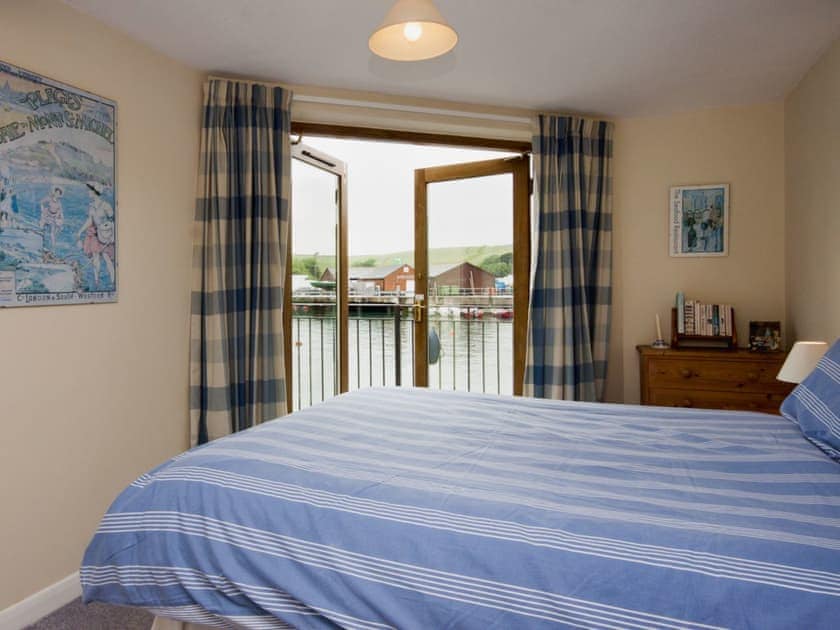 Double bedroom with patio doors to balcony overlooking the water | Tappers Quay 4, Salcombe