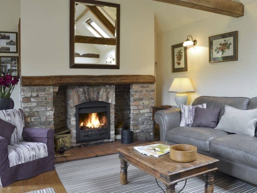 Stylish living room with wood-burner | Wisteria Cottage - Wisteria and Rusty’s Cottages, Buttercrambe, near York
