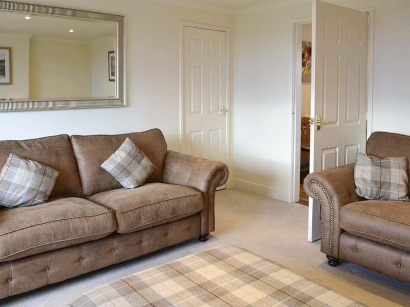 Comfy seating in living room | Foulden Hill Farm Cottage, Foulden
