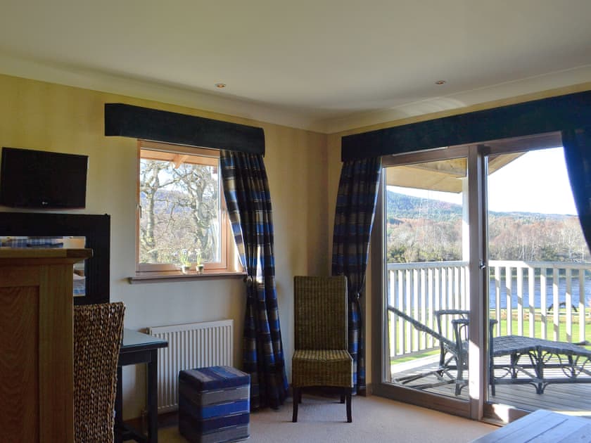 Sylish double bedroom with patio doors leading onto a balcony | River Lodge - Ness Castle Estate, Inverness