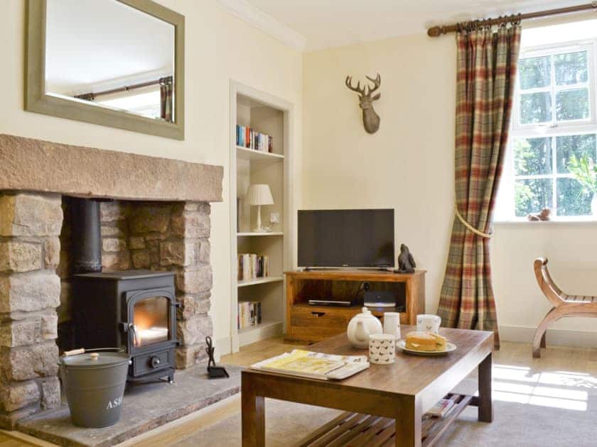 Beautifully presented living room with wood-burning stove | Curlew Cottage - Strathisla Farm Cottages, Meigle