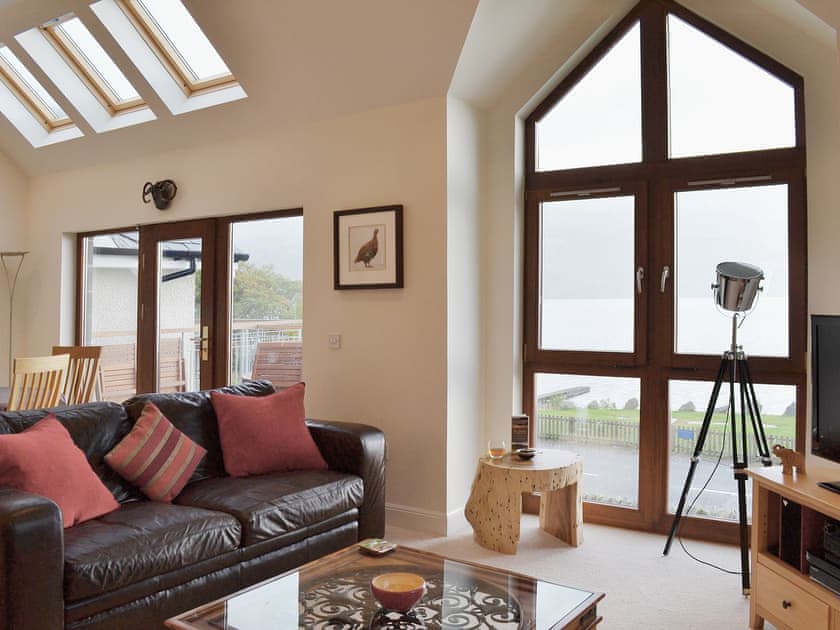 Large open plan living area with patio doors leading onto the balcony | The Quaich, Fearnan, by Aberfeldy