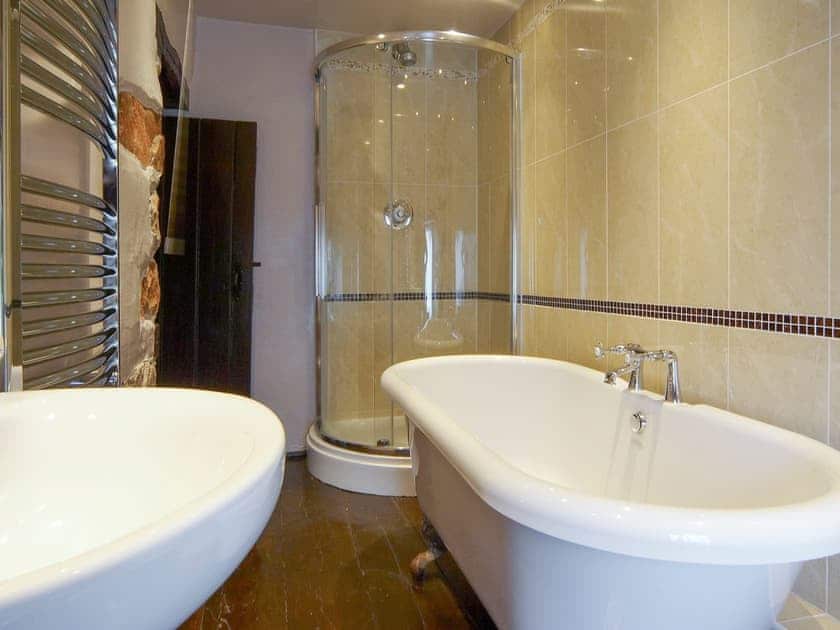 Bathroom with roll-top bath and shower cubicle | Bridge End Farmhouse - Bridge End Farm Cottages, Boot, near Eskdale