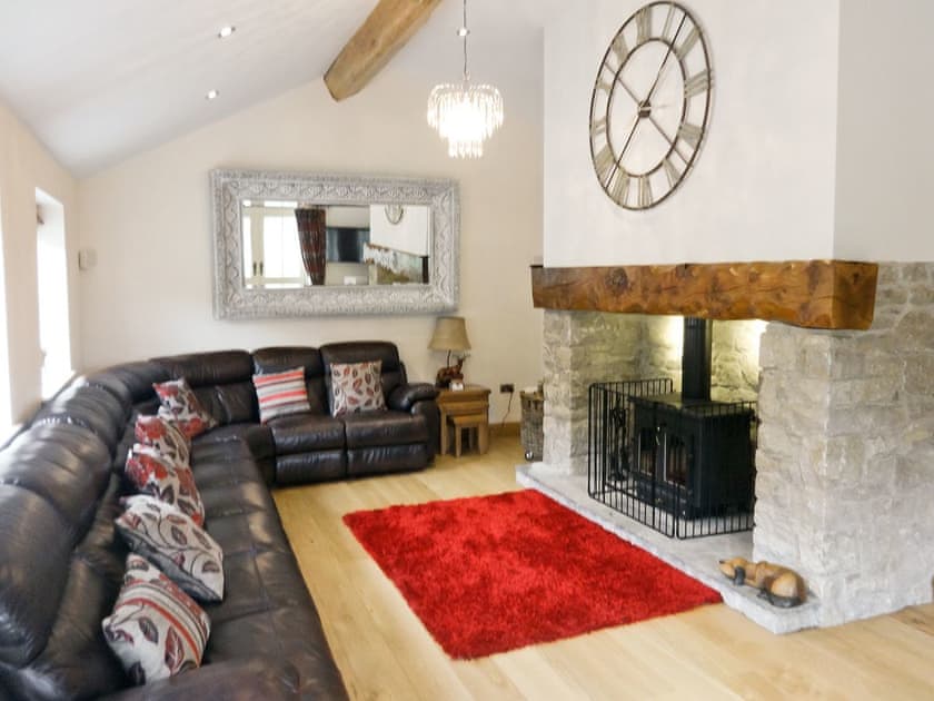 Large beamed living room with wood-burning stove | Pheasant Fields - Holly and Pines Holidays, Holywell