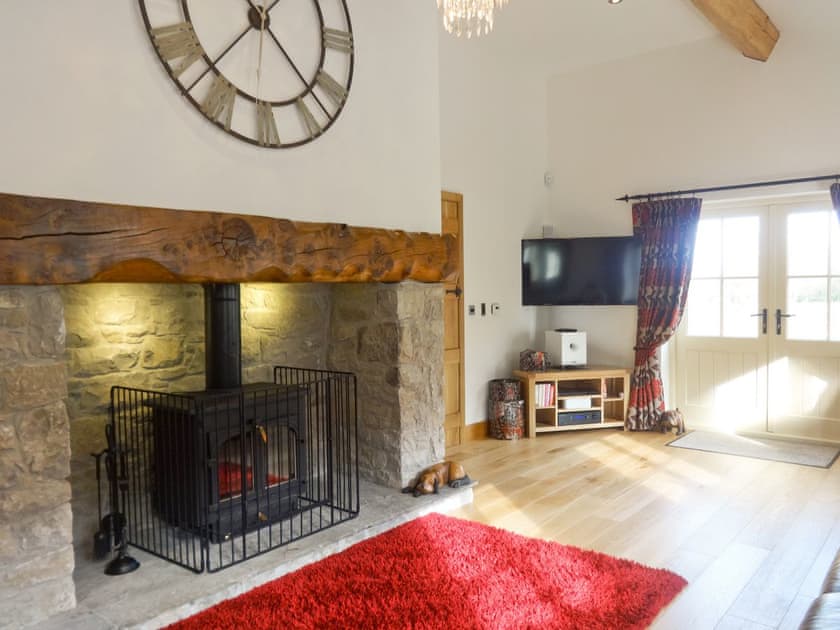 Large beamed living room with wood-burning stove | Pheasant Fields - Holly and Pines Holidays, Holywell