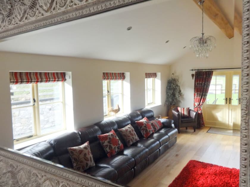 Large beamed living room with wood-burning stove | Pheasant Fields - Holly and Pines Holidays, Holywell