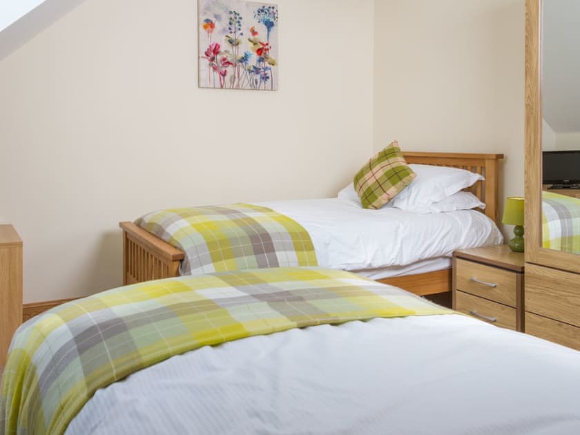 Twin bedroom with ample storage and flat-screen TV | Seascape - Seascape Cottages, Southerness, near Dumfries