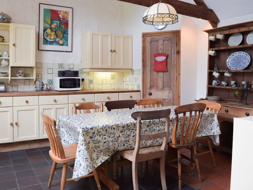 Large kitchen dining table in the beamed kitchen/diner | Lordship FarmhousePottery, Wolfscastle, near Haverfordwest