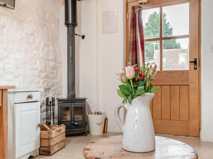 Wood-burning stove in lounge area | The Dairy - Milton End Farm Barns, Arlingham, near Frampton-on-Severn
