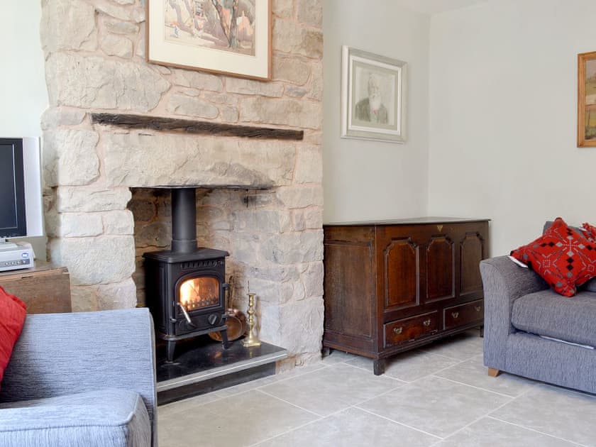 Characterful living room with cosy wood burner | The Mill Farmhouse (Ty Fferm Y Felin), Llandybie, near Llandeilo