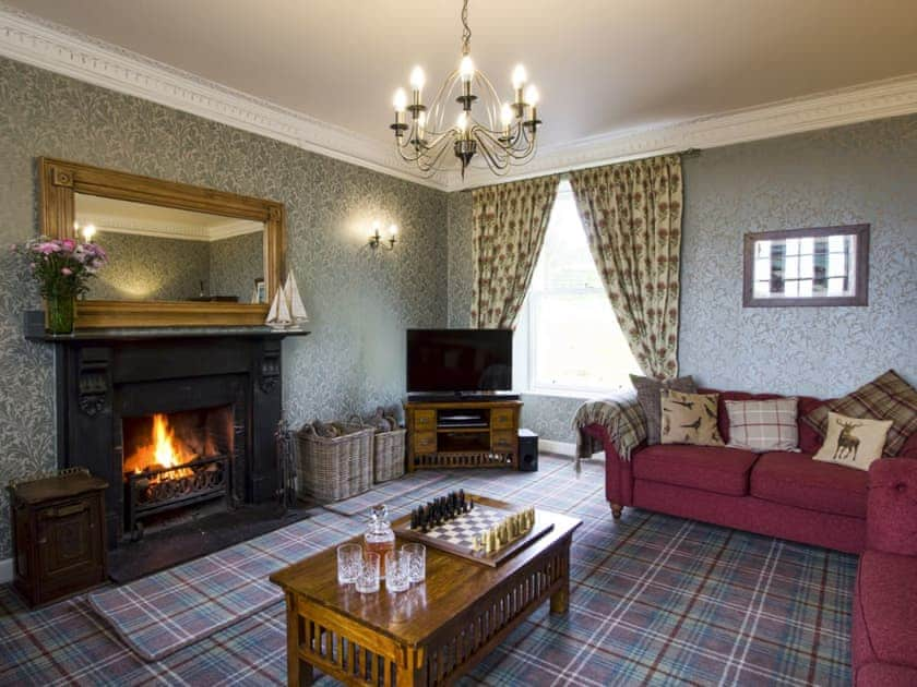 Grand living room with open fireplace | Drummuie House, Golspie