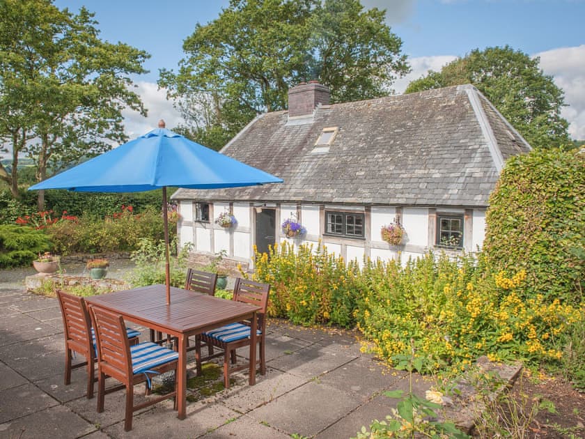 Exterior of the A Grade II listed 17th century timber and stone holiday cottage | Pen Copi, Trefeglwys, near Caersws