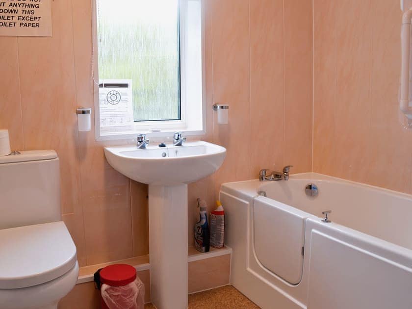 Bathroom with shower over bath | Sunshine Cottage, Fairford, near Cirencester