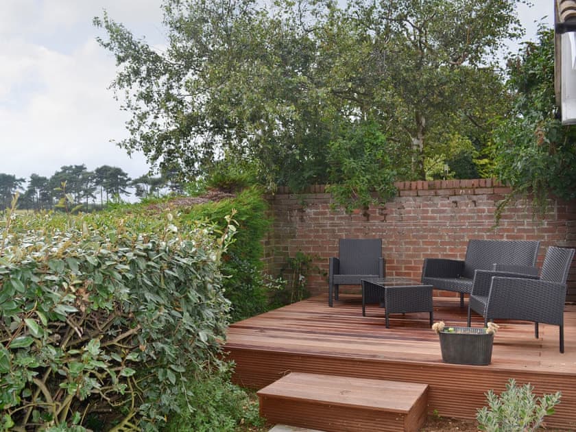 Attractive terraced decking with comfortable outdoor seating | The Seashells, Brancaster Staithe, near Hunstanton