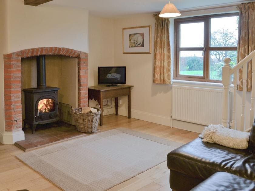 Cosy living room with wood burner | Blackthorn Cottage, Norton Disney, near Newark